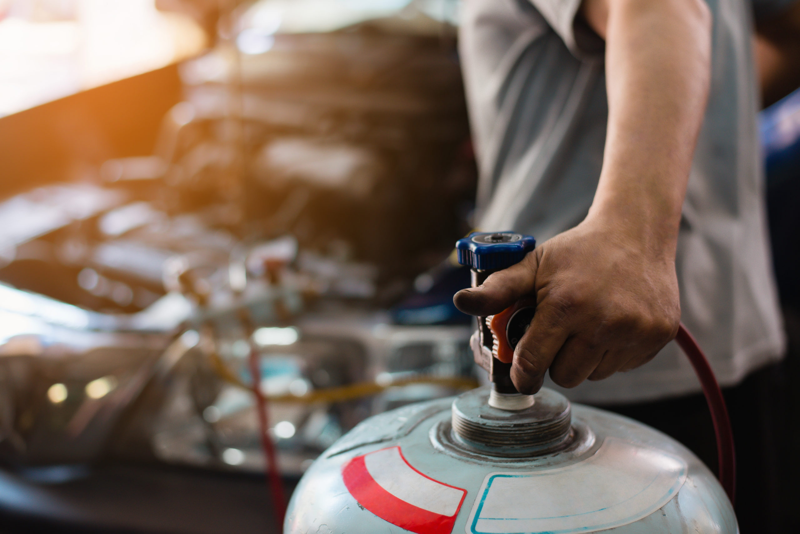 Servicing car air conditioner. Service station. Car repair,manom